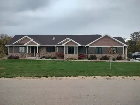 Beautiful house with new siding and roofing by Arrow Exteriors.