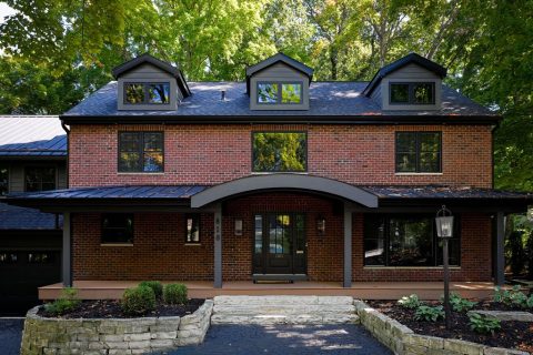 Beautiful brick house with dormer windows and landscaped yard in Madison.