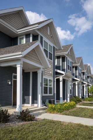 Contemporary townhomes with modern siding and architecture in a residential neighborhood.