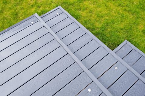 Close-up of gray composite decking boards on outdoor patio.