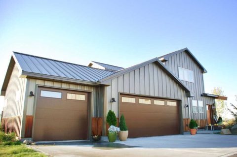 Contemporary home with metal siding and three garage doors.