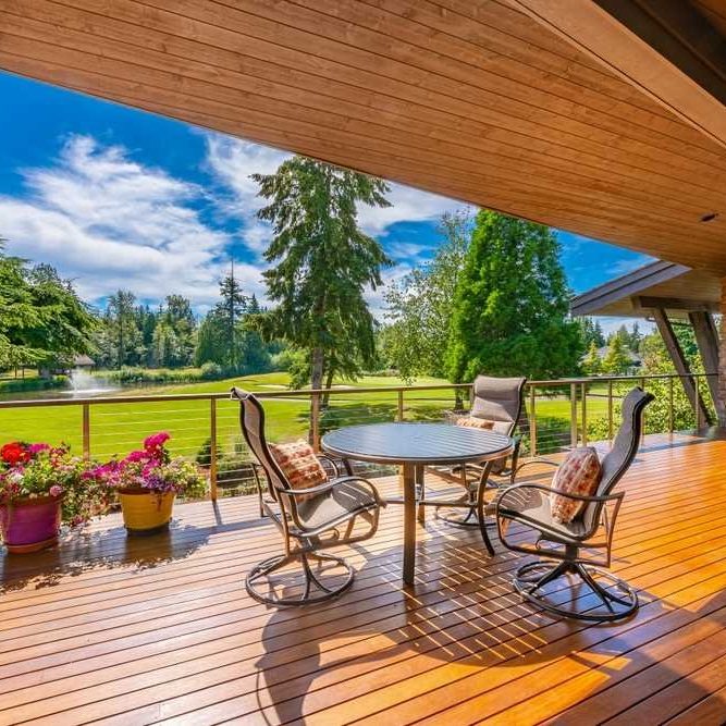 luxury-covered-wood-deck-cable-railing-scenic-view-arrow-exterior-design-wisconsin
